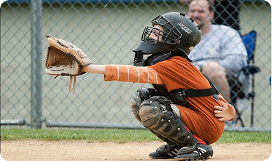 Young catcher preparing to receive the pitch